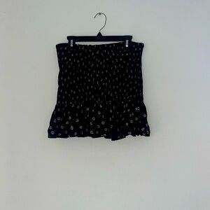 Black mini skirt with small white flowers;size small